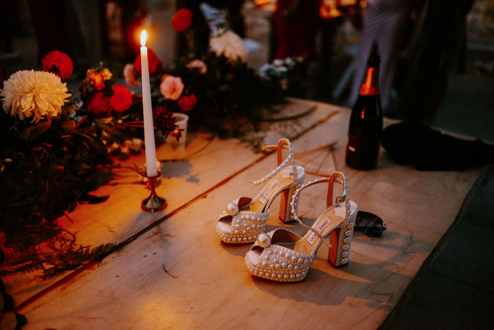 Jimmy Choo shoes on table by candle light