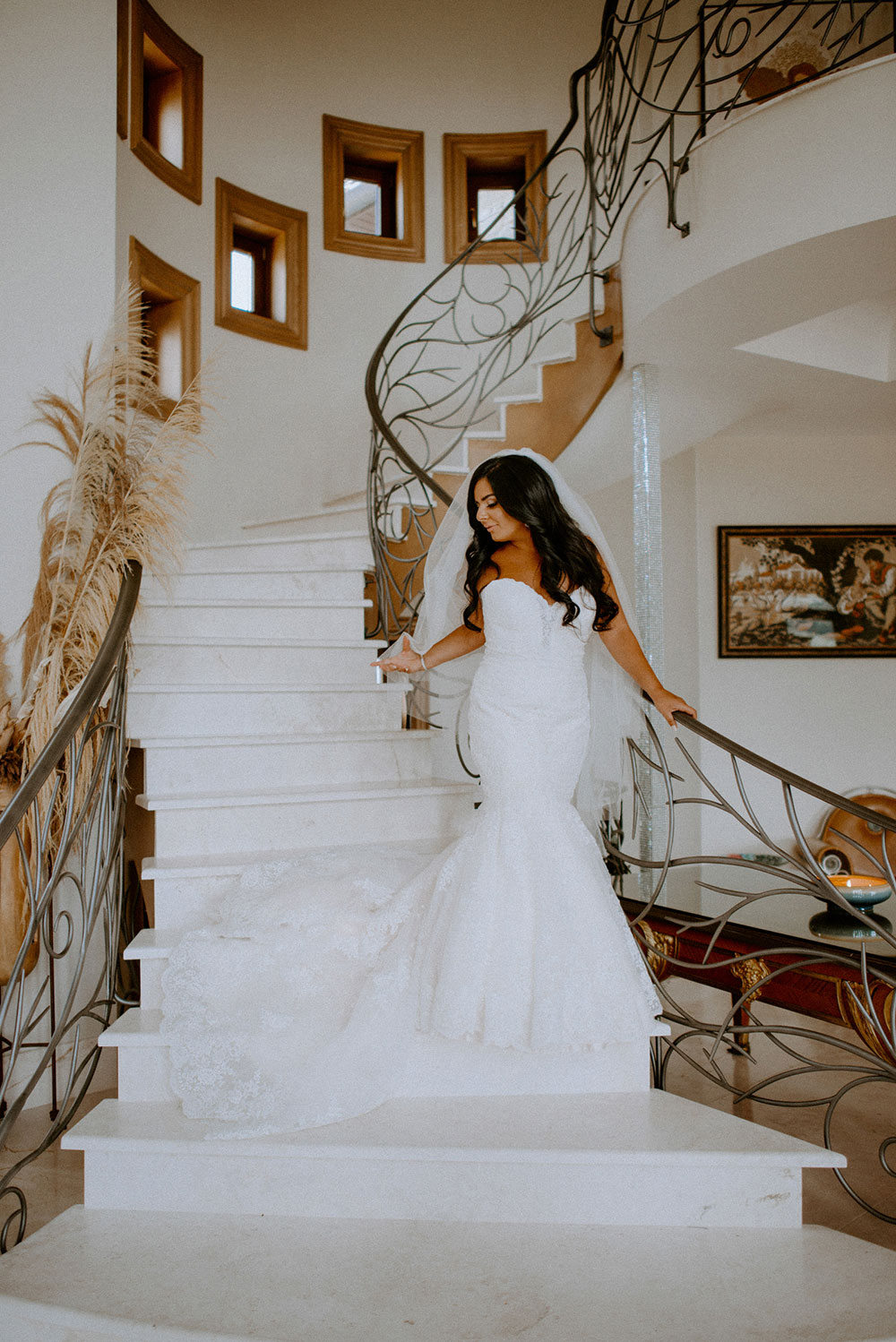 Bride walks down the grand staircase at the Catana Estate