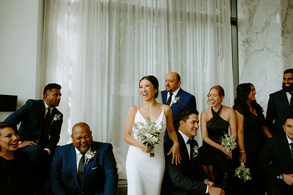 mildred's temple kitchen wedding photography of the wedding party posing candidly for their portrait