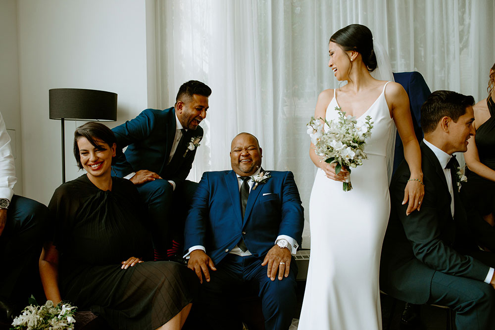 mildred's temple kitchen wedding photography of the wedding party posing candidly for their portrait