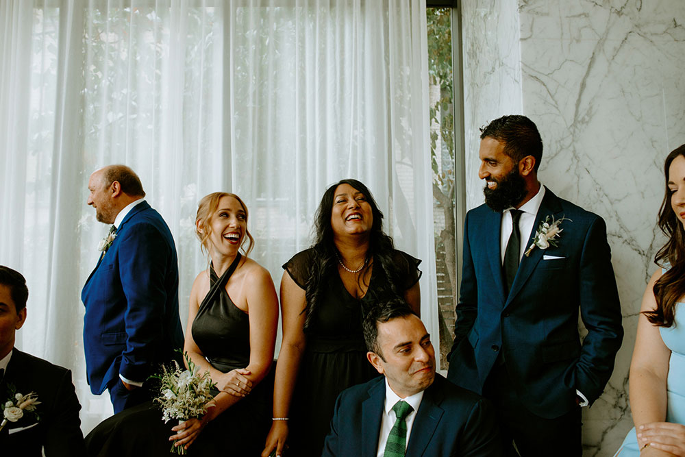 mildred's temple kitchen wedding photography of the wedding party posing candidly for their portrait