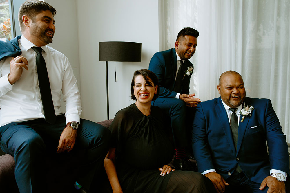 mildred's temple kitchen wedding photography of the wedding party posing candidly for their portrait