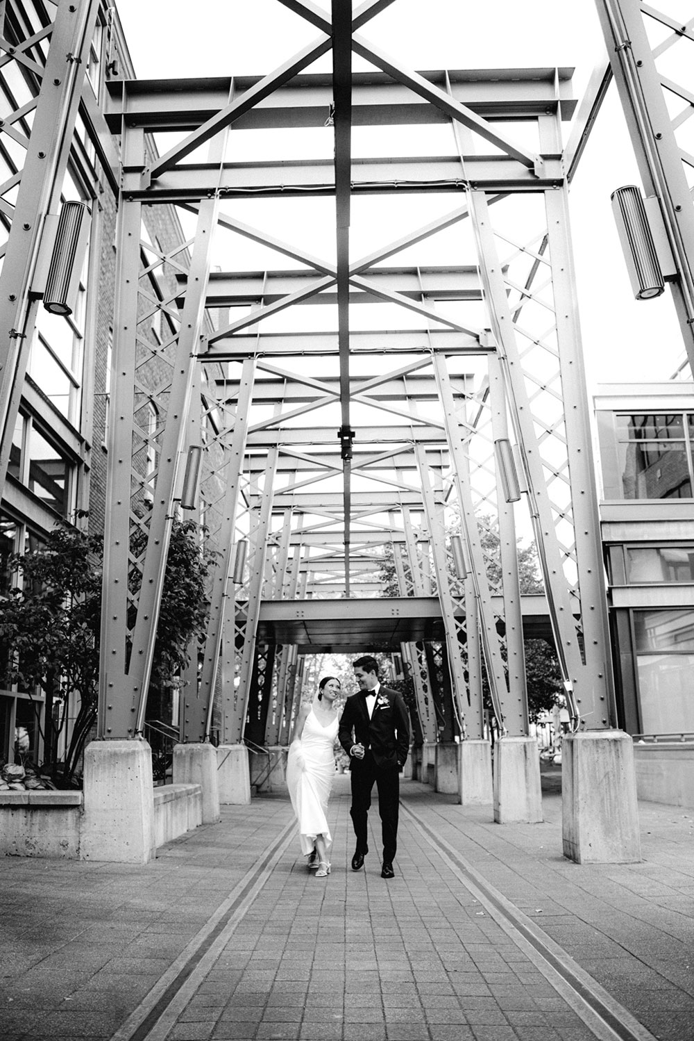 mildred's temple kitchen wedding photography of the wedding couple candidly walking around liberty village