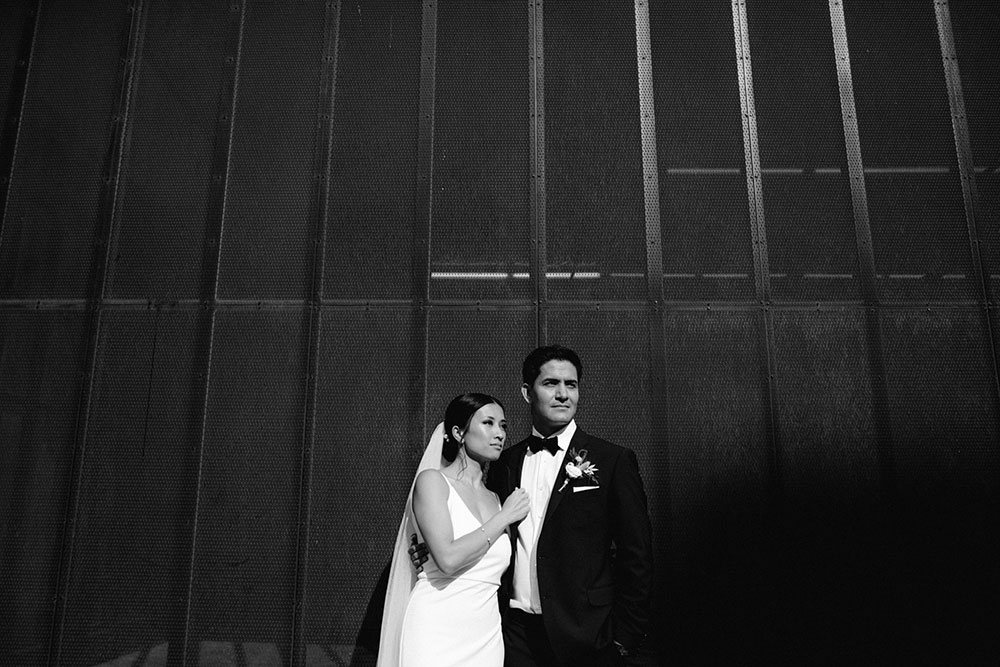 mildred's temple kitchen wedding photography of the wedding couple candidly posing around liberty village