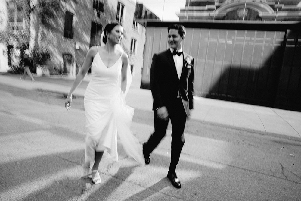 mildred's temple kitchen wedding photography of the wedding couple candidly walking around liberty village