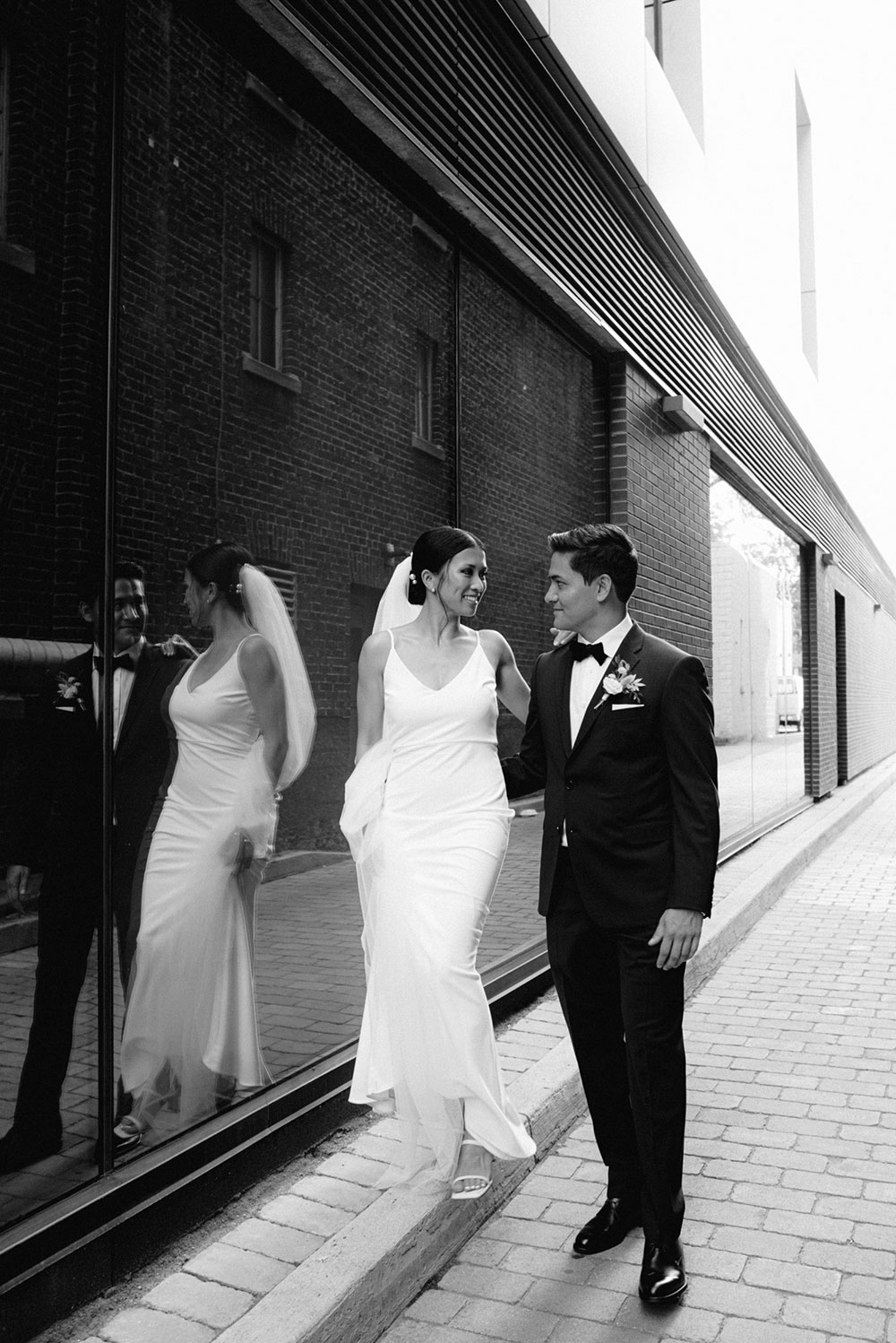 mildred's temple kitchen wedding photography of the wedding couple candidly walking around liberty village