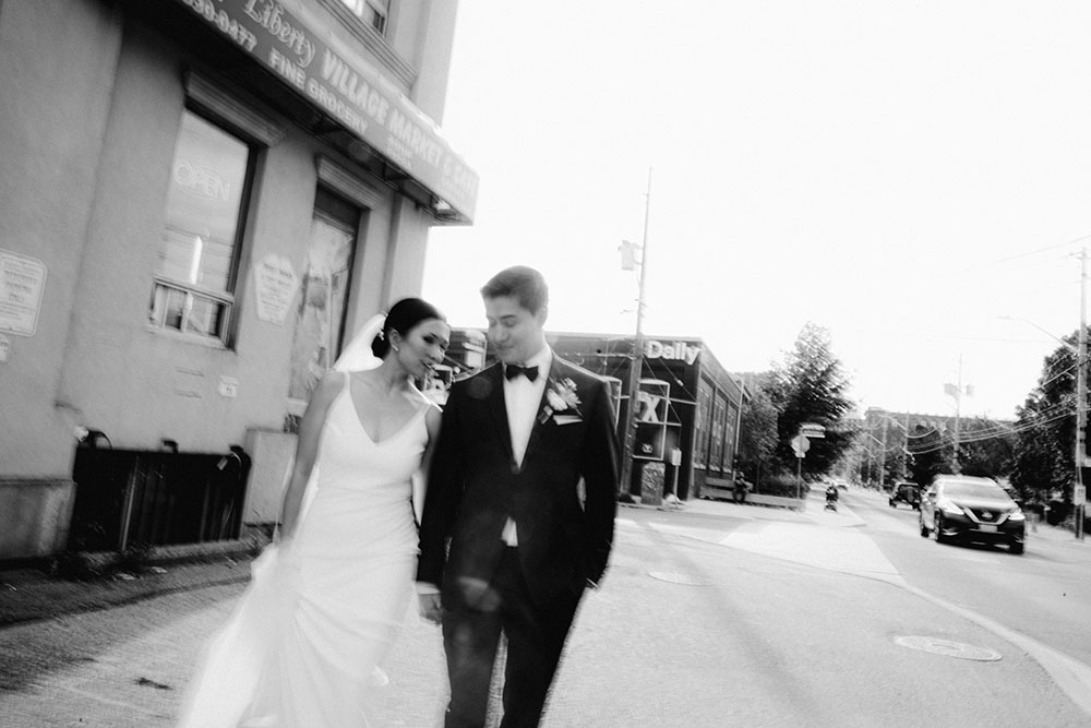 mildred's temple kitchen wedding photography of the wedding couple candidly walking around liberty village