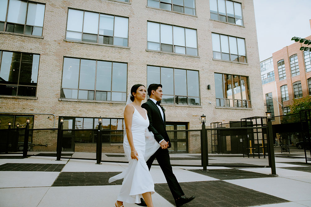 mildred's temple kitchen wedding photography of the wedding couple candidly walking around liberty village