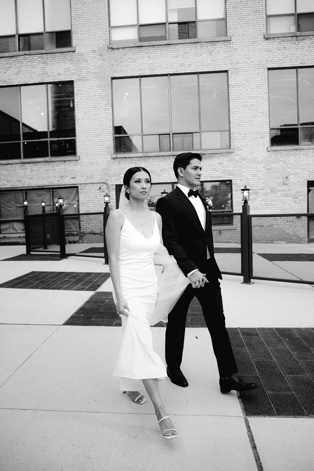 mildred's temple kitchen wedding photography of the wedding couple candidly walking around liberty village