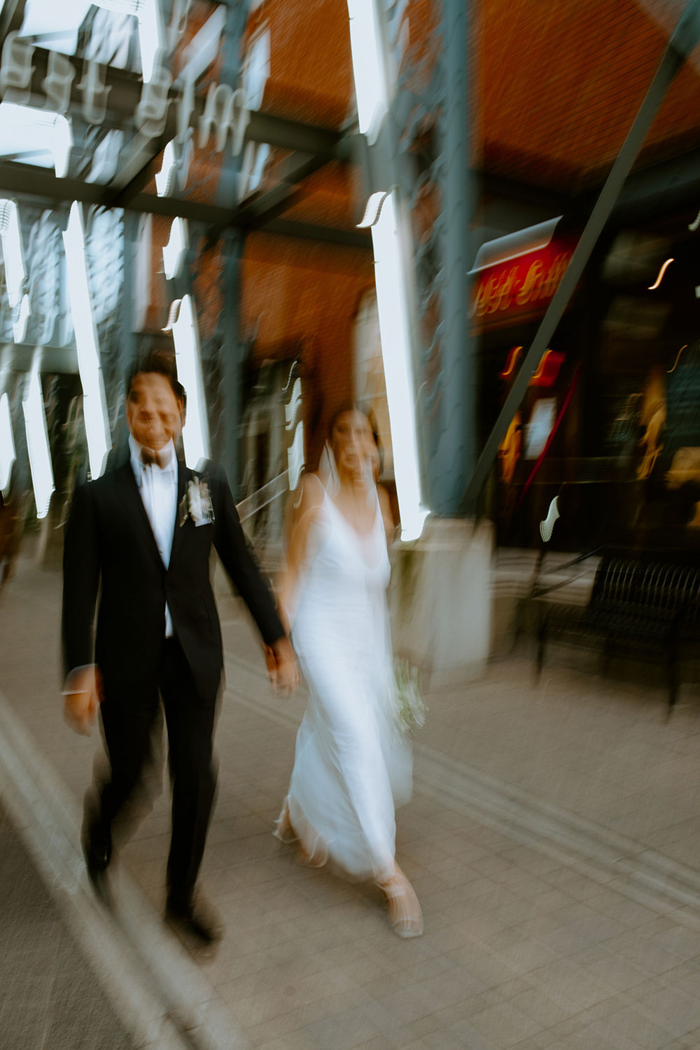 mildred's temple kitchen wedding photography of the wedding couple being candid around liberty village at sunset