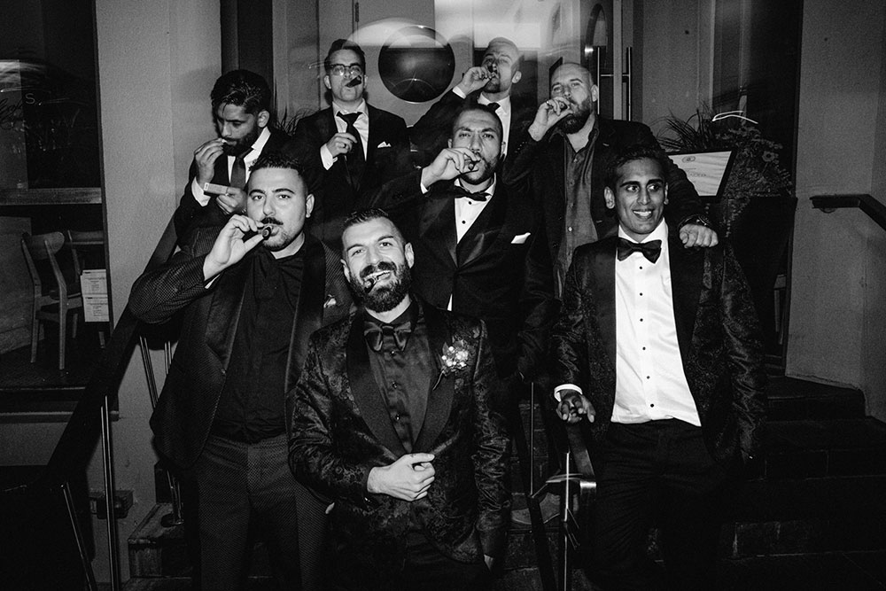 Sassafraz Yorkville Wedding Photography of the wedding party sharing cigars