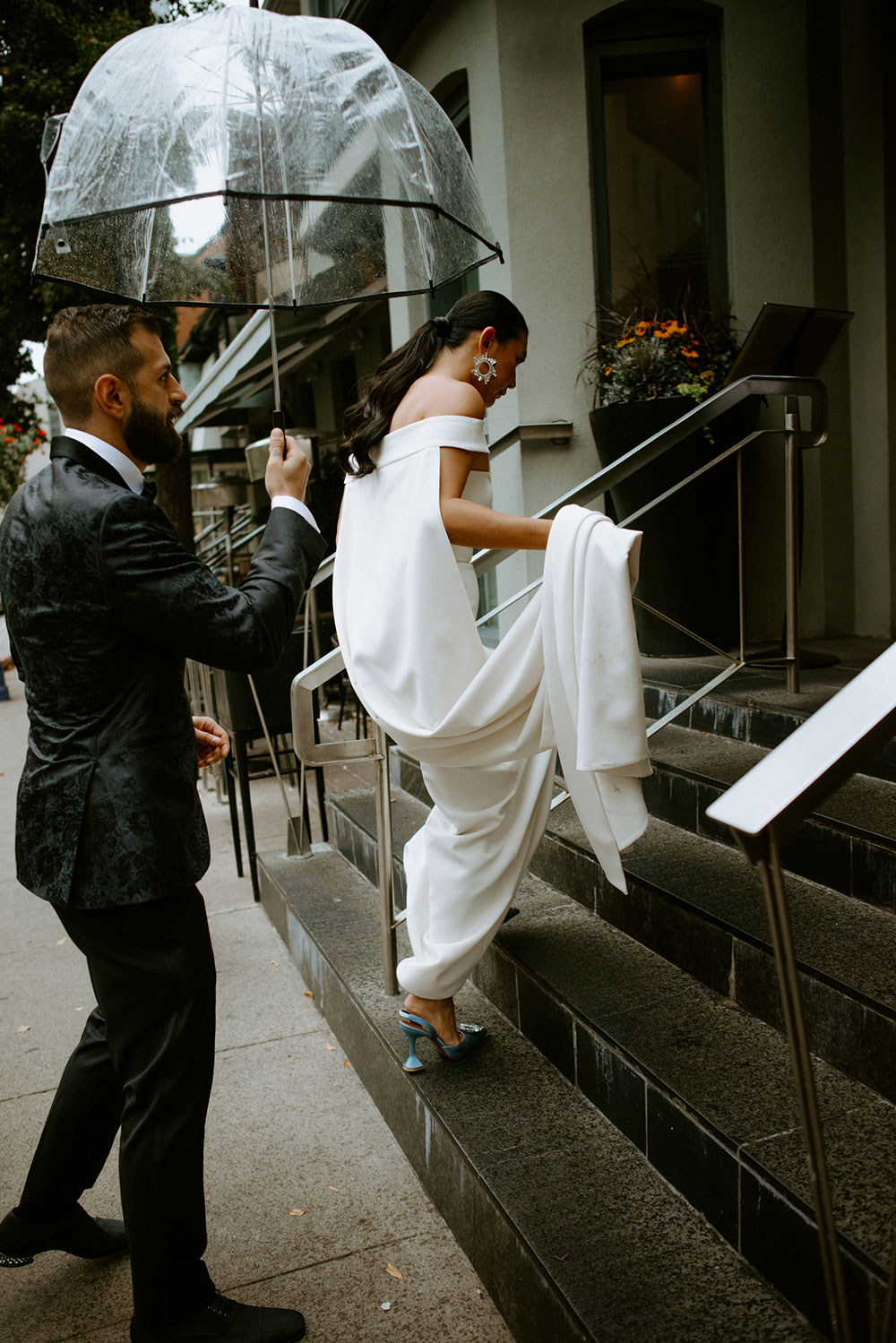 Sassafraz Yorkville Wedding Photography of the bride & groom sharing an umbrella around yorkville