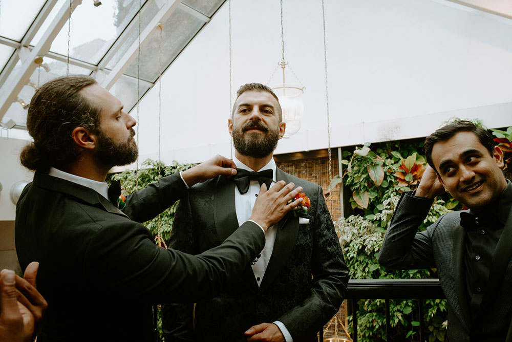 Sassafraz Yorkville Wedding Photography of the best man fixing the groom's bow tie