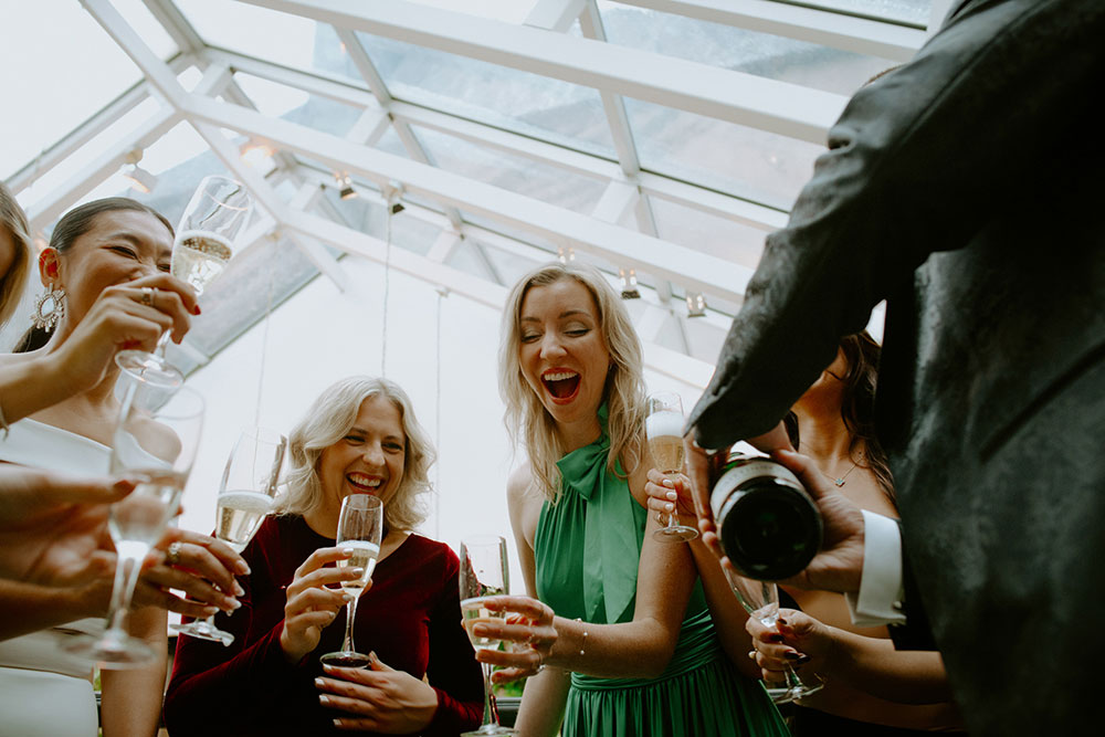 Sassafraz Yorkville Wedding Photography of the guests and the bride sharing champagne