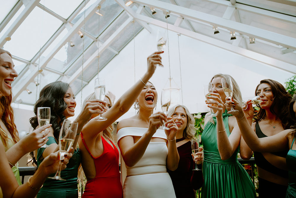 Sassafraz Yorkville Wedding Photography of the bride and bridesmaids sharing champagne