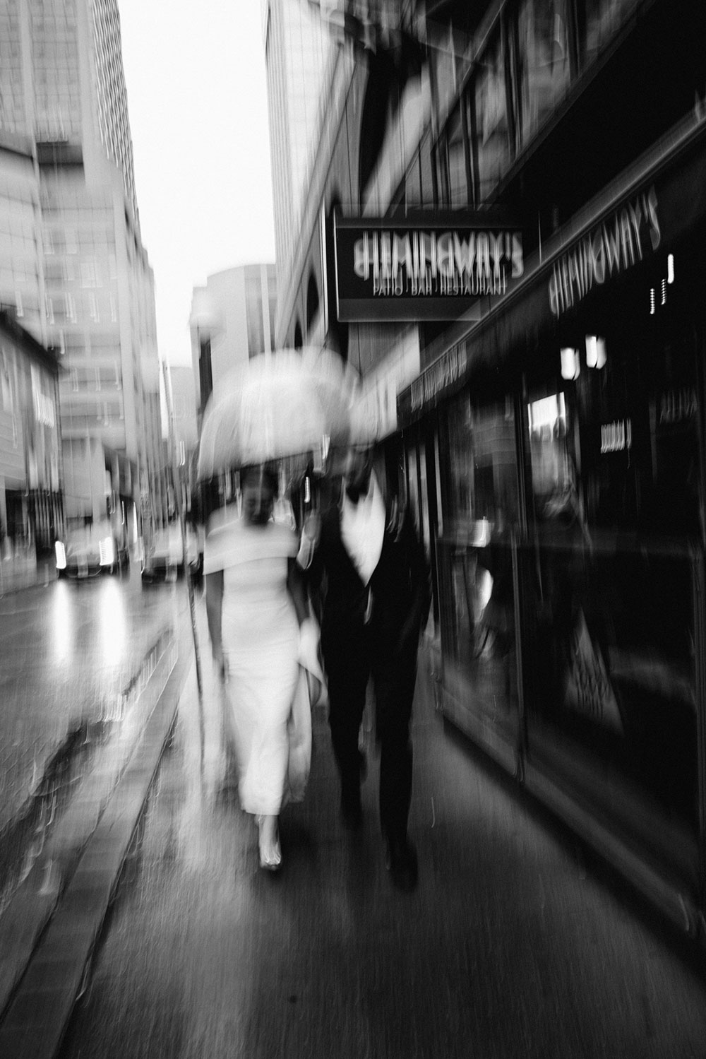 Sassafraz Yorkville Wedding Photography of the wedding couple walking candidly together in the rain