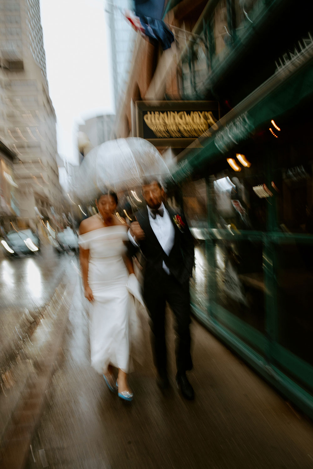 Sassafraz Yorkville Wedding Photography of the wedding couple walking candidly together in the rain