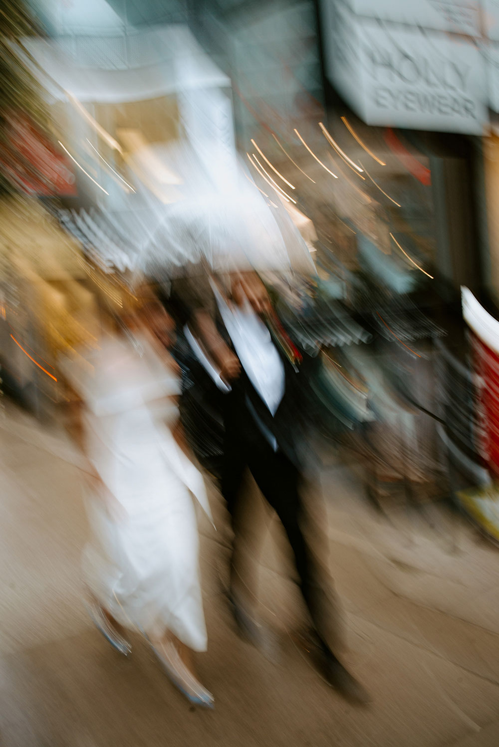 Sassafraz Yorkville Wedding Photography of the wedding couple walking candidly together in the rain