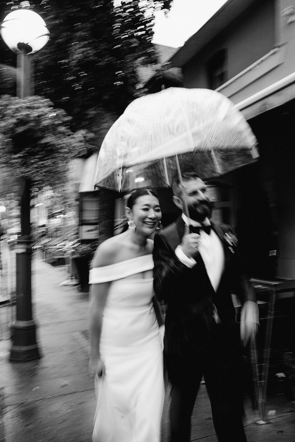 Sassafraz Yorkville Wedding Photography of the wedding couple walking candidly together in the rain