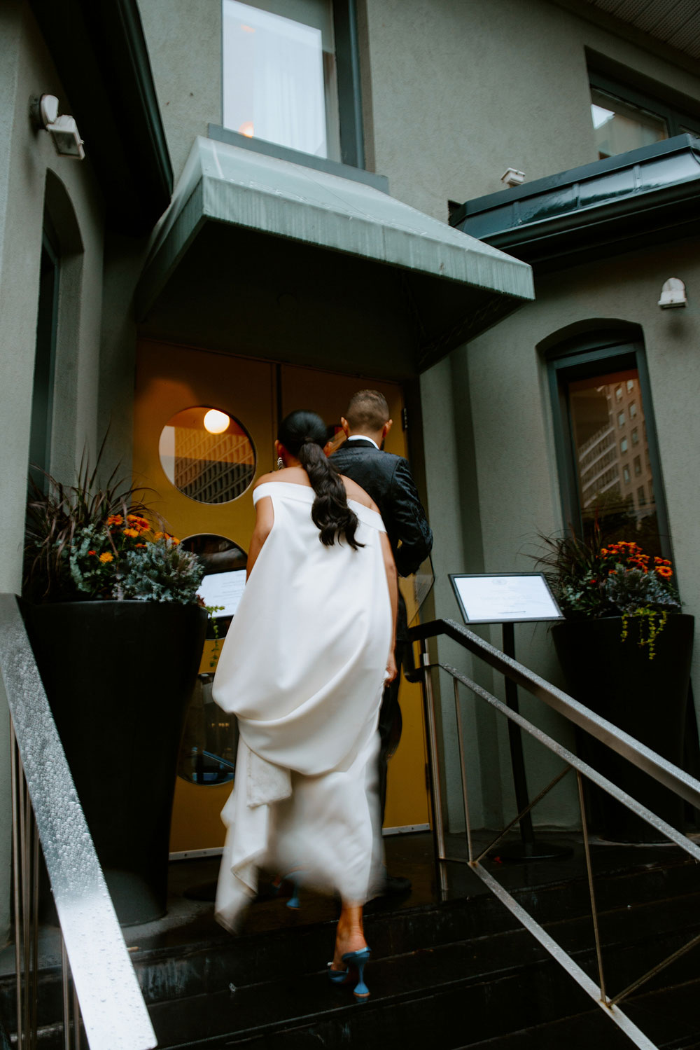 Sassafraz Yorkville Wedding Photography of the wedding couple walking candidly together in the rain