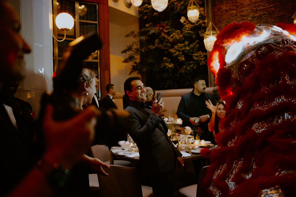 Sassafraz Yorkville Wedding Photography of the weddin guests during the wedding reception watching the lion dancers