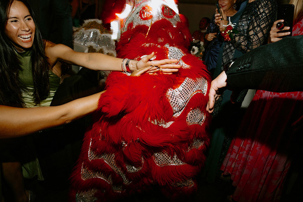 Sassafraz Yorkville Wedding Photography of the weddin guests during the wedding reception watching the lion dancers