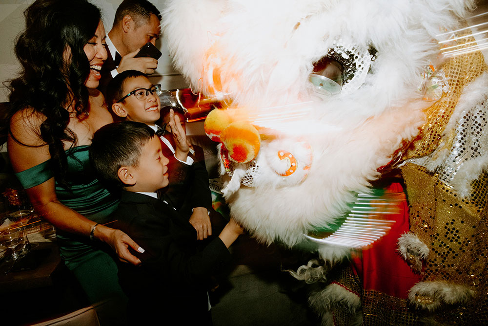 Sassafraz Yorkville Wedding Photography of the weddin guests during the wedding reception watching the lion dancers