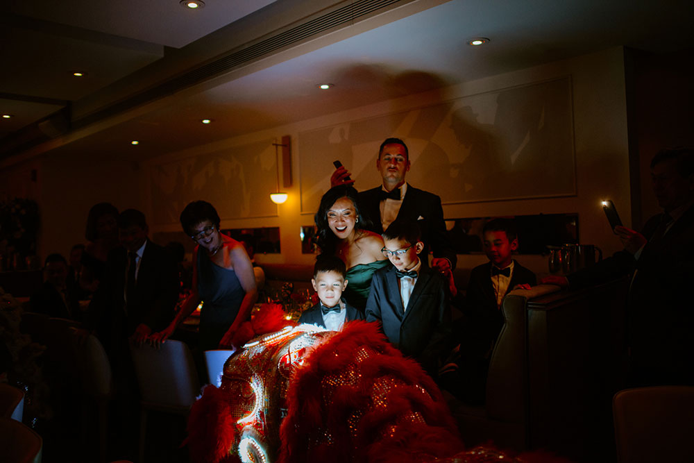 Sassafraz Yorkville Wedding Photography of the weddin guests during the wedding reception watching the lion dancers