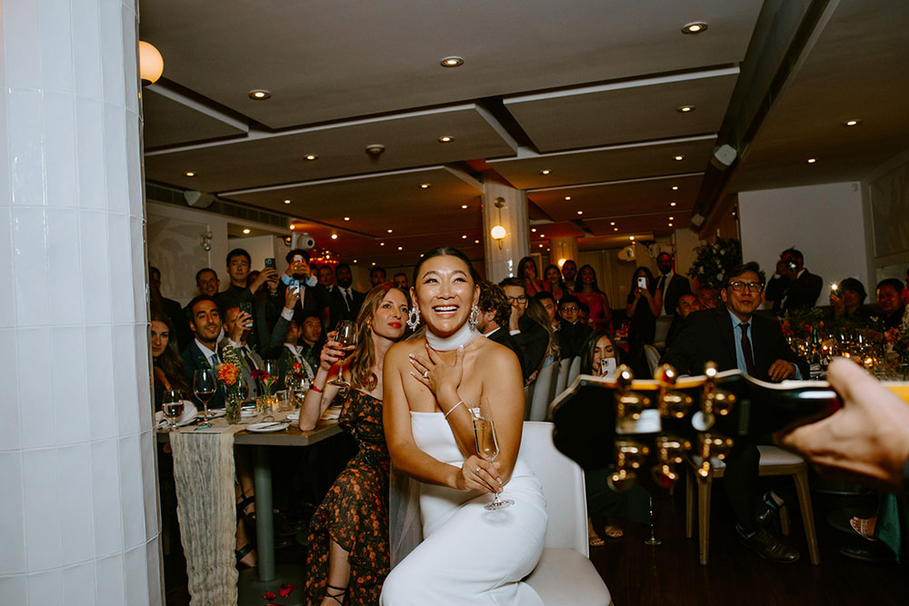 Sassafraz Yorkville Wedding Photography of the groom serenading his bride in front of all the guests during the wedding reception