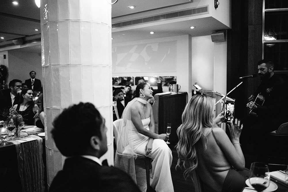 Sassafraz Yorkville Wedding Photography of the groom serenading his bride in front of all the guests during the wedding reception