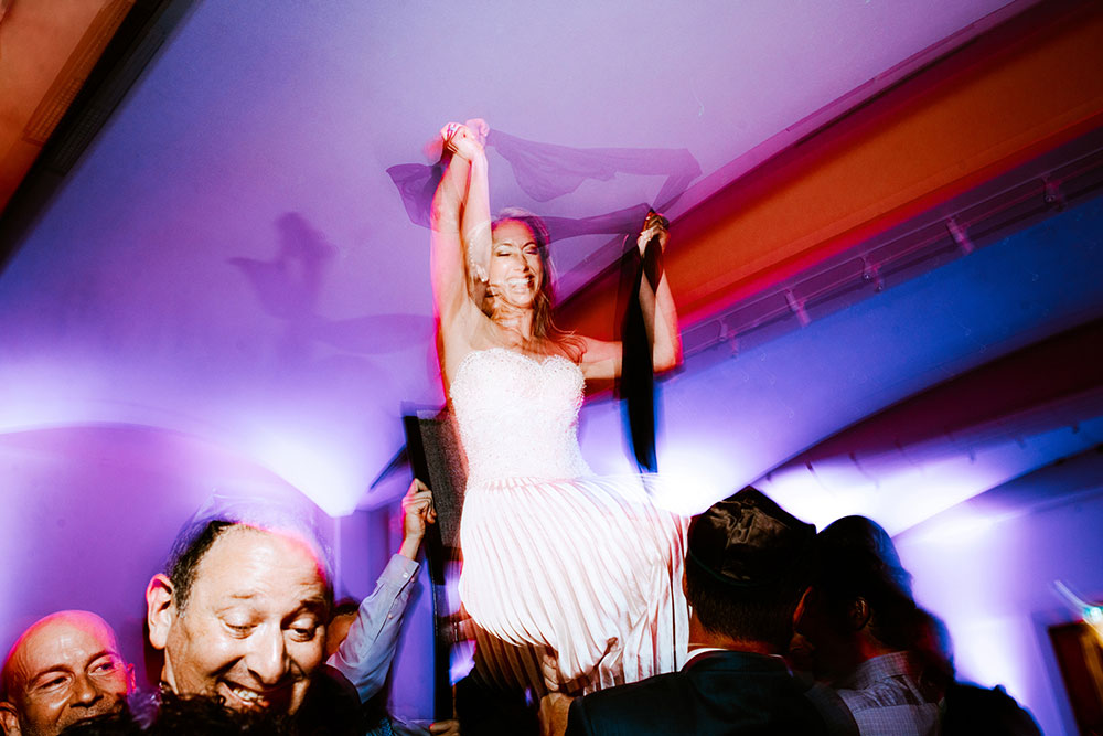 Bride is lifted in a traditional Hora Dance 