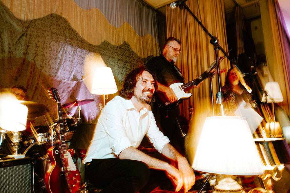 Band member smiles while on stage at a Jewish Wedding Held at Toronto Temple
