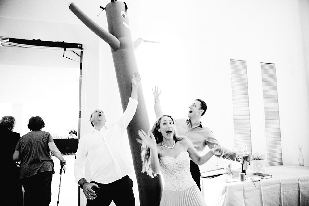 Bride and groom dance with inflatable tube man at a Toronto Jewish Wedding 