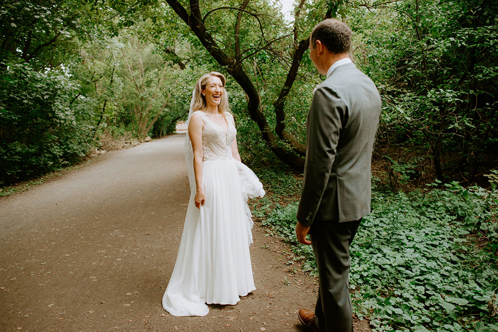 Bride and groom meet on a foresty pathway in Toronto for the first look before the ceremony