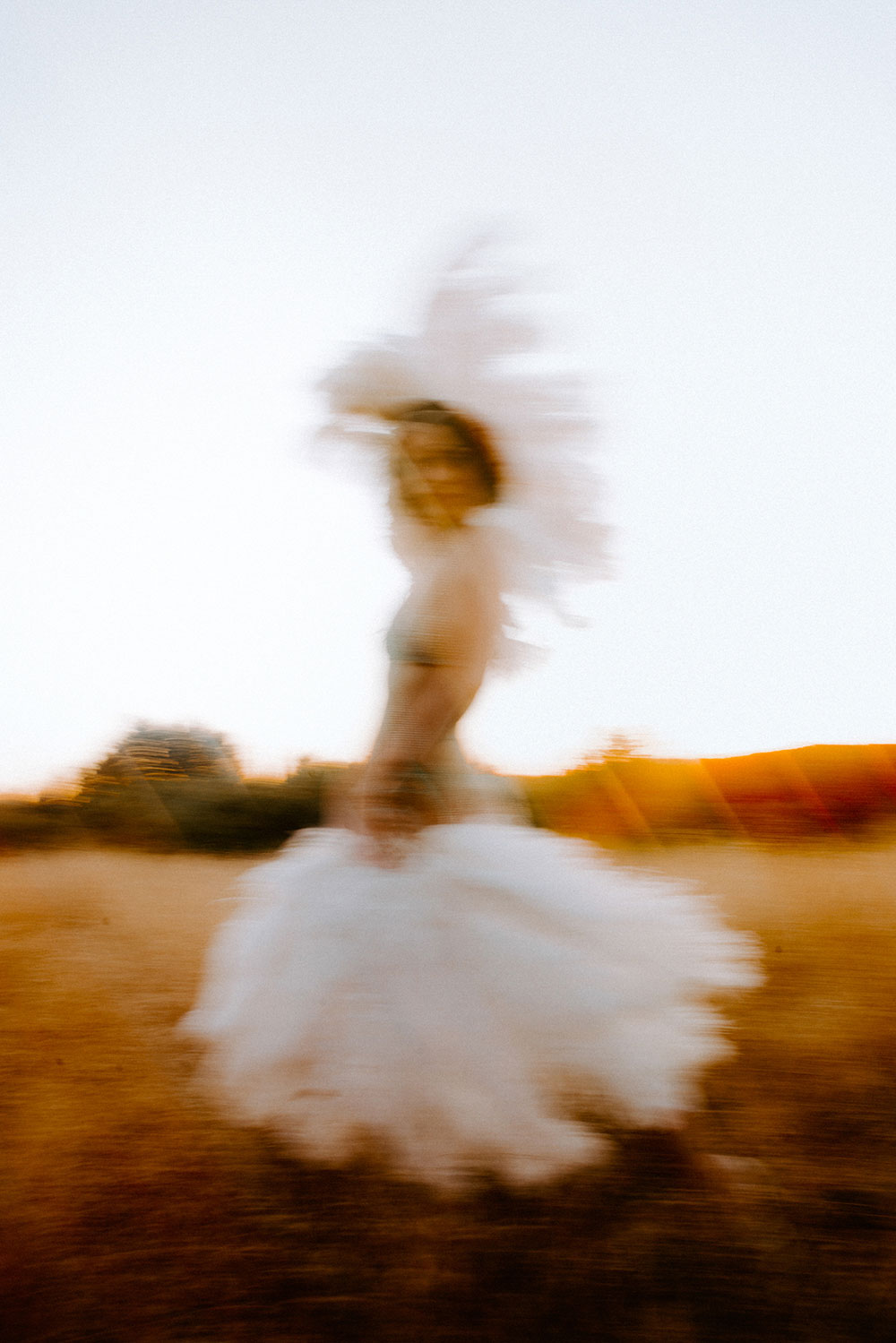 Commercial Photography of Starlotte Satine Toronto Burlesque Dancer in a field wielding large feather fans