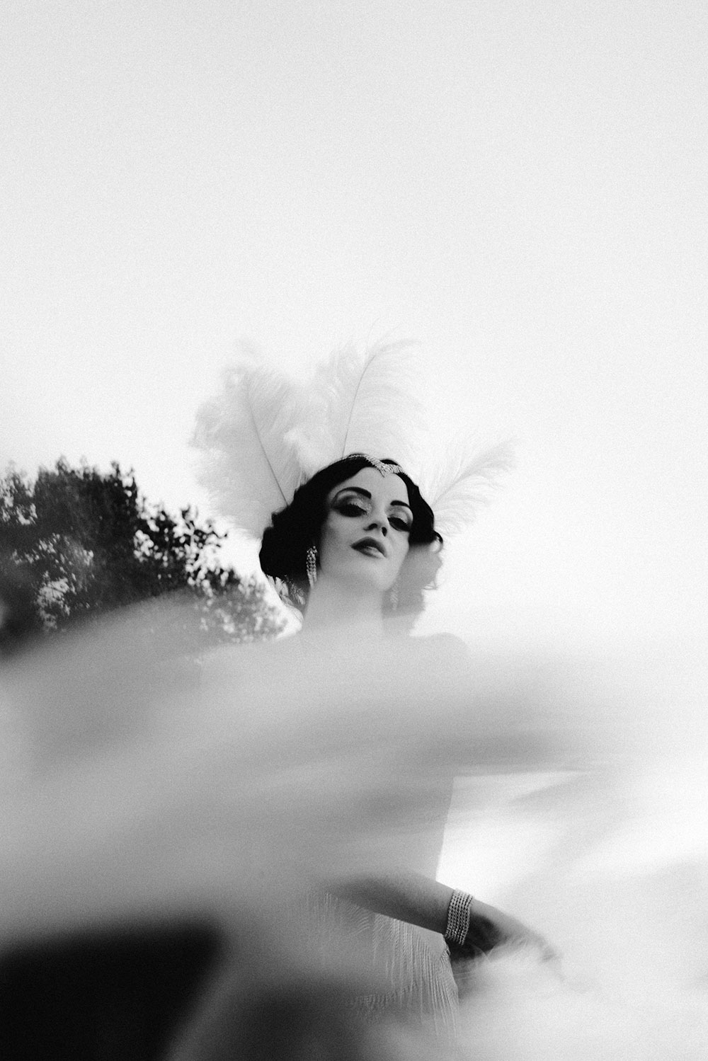 Commercial Photography of Starlotte Satine Toronto Burlesque Dancer in a field wielding large feather fans