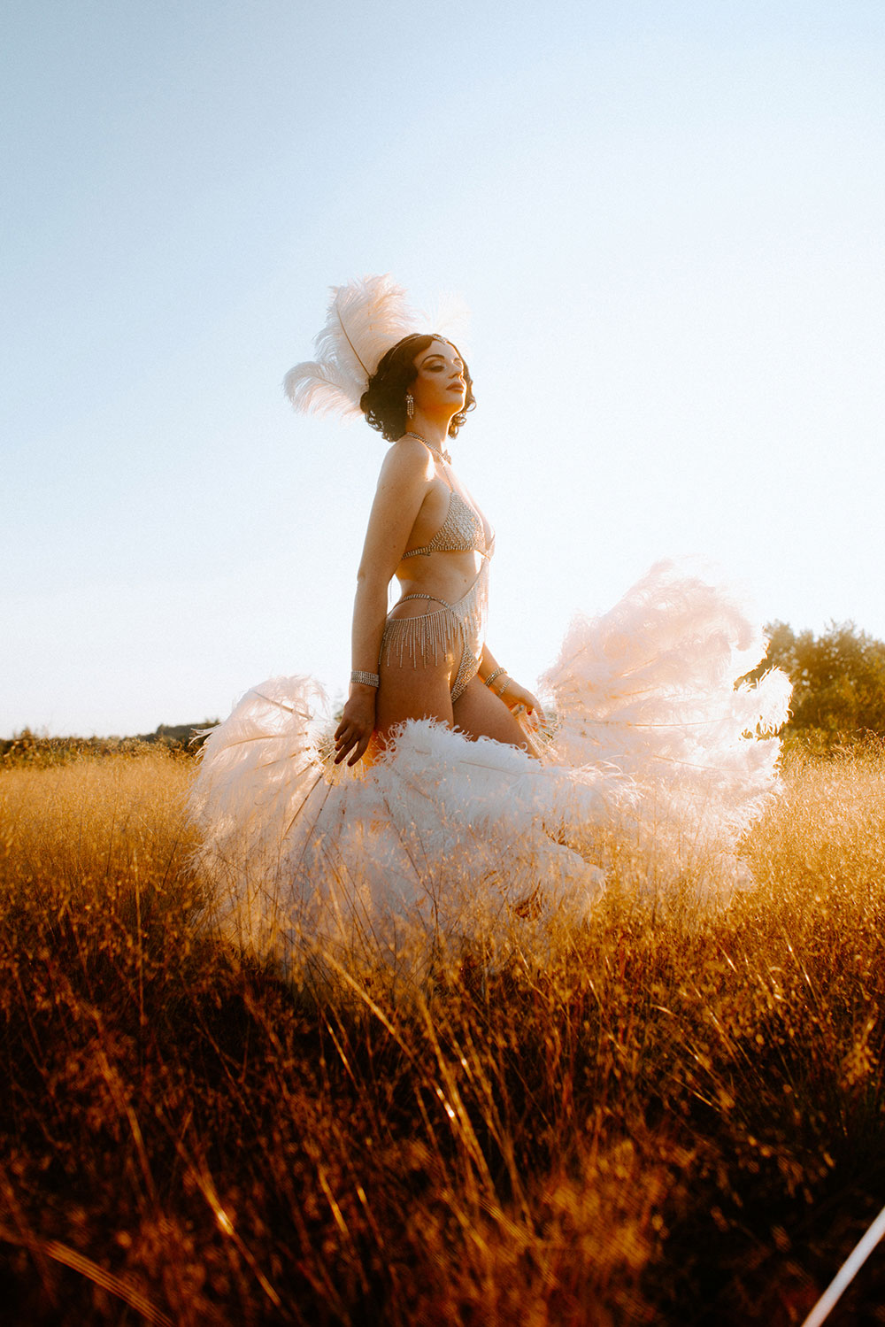 Commercial Photography of Starlotte Satine Toronto Burlesque Dancer in a field wielding large feather fans