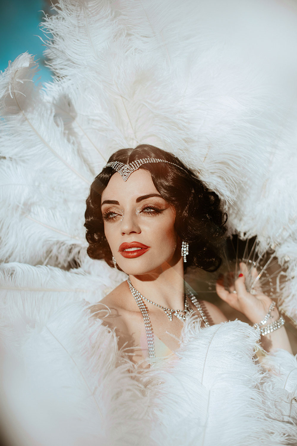 Commercial Photography of Starlotte Satine Toronto Burlesque Dancer in a field wielding large feather fans