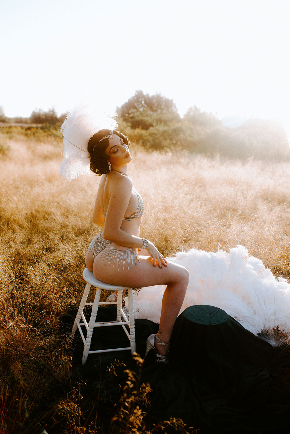 Commercial Photography of Starlotte Satine Toronto Burlesque Dancer in a field wielding large feather fans