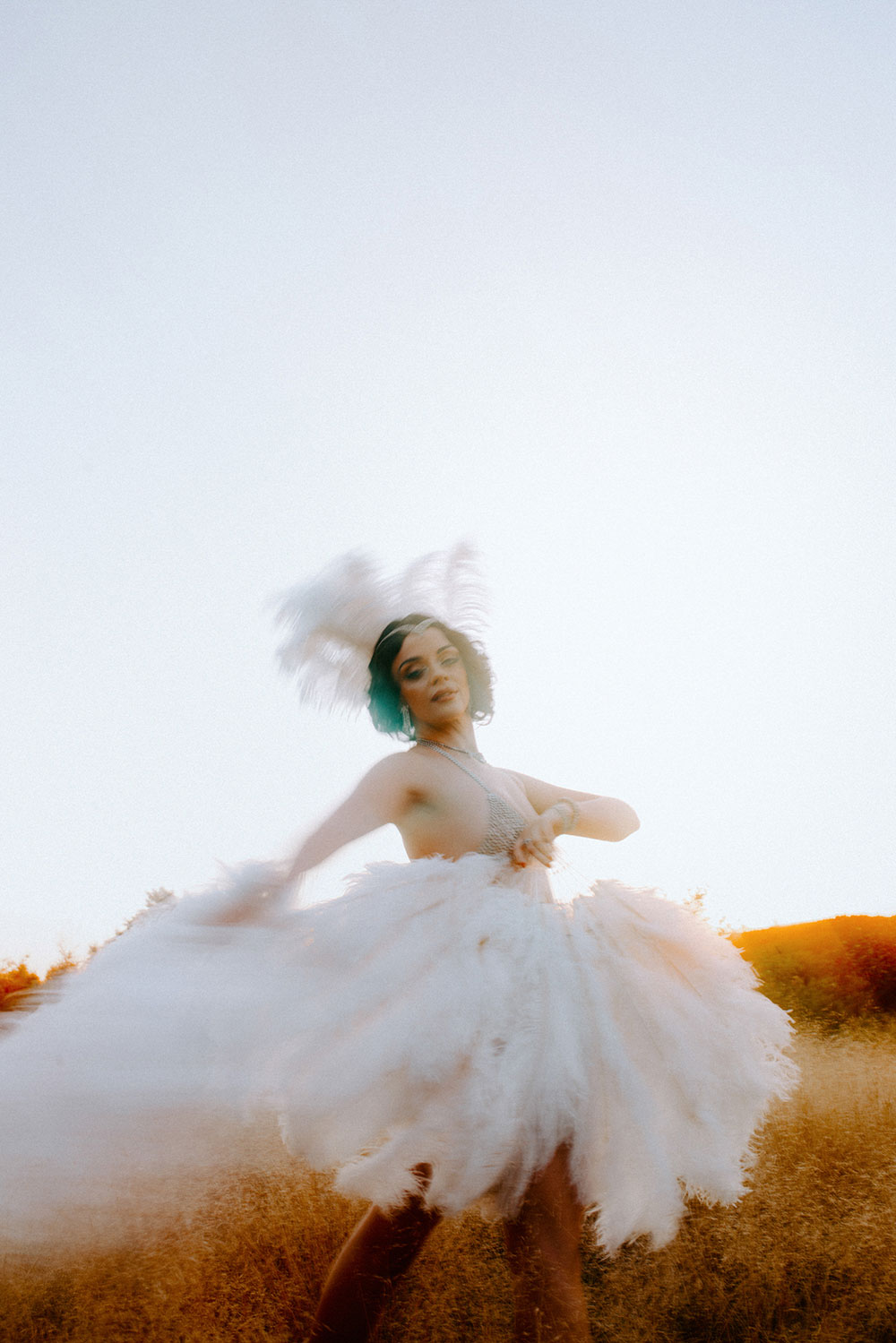 Commercial Photography of Starlotte Satine Toronto Burlesque Dancer in a field wielding large feather fans