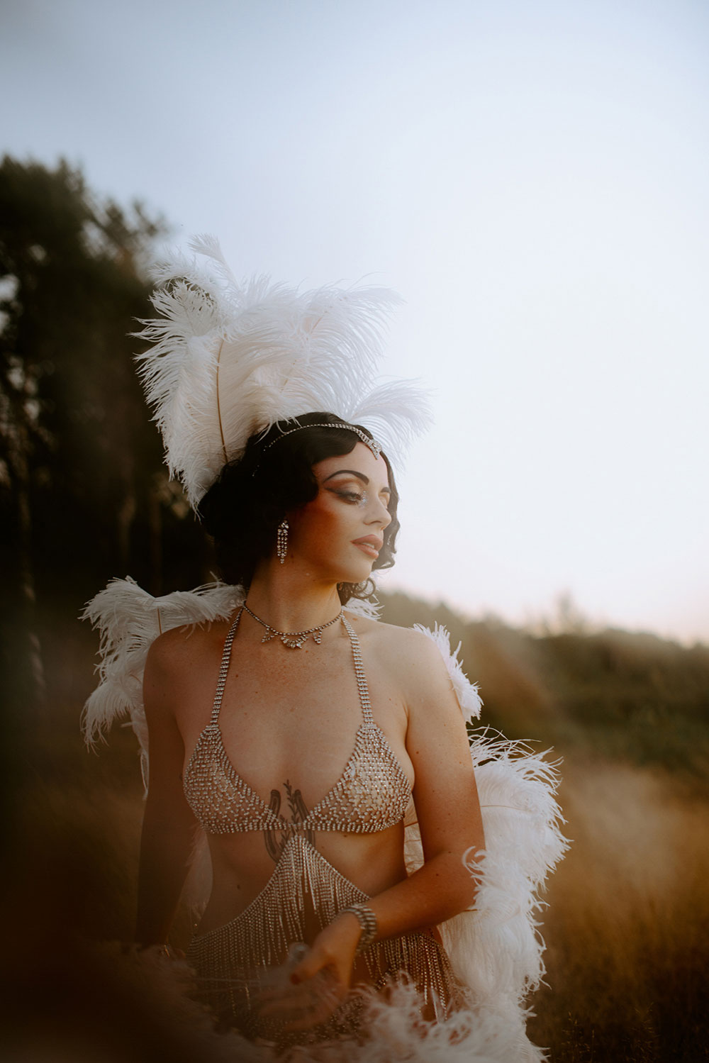 Commercial Photography of Starlotte Satine Toronto Burlesque Dancer in a field wielding large feather fans