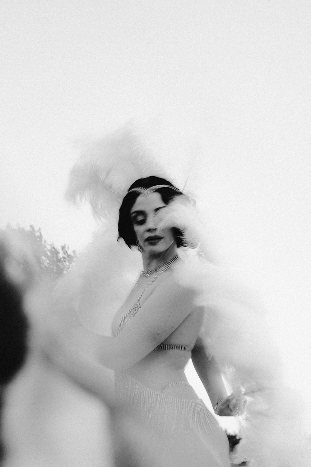 Commercial Photography of Starlotte Satine Toronto Burlesque Dancer in a field wielding large feather fans