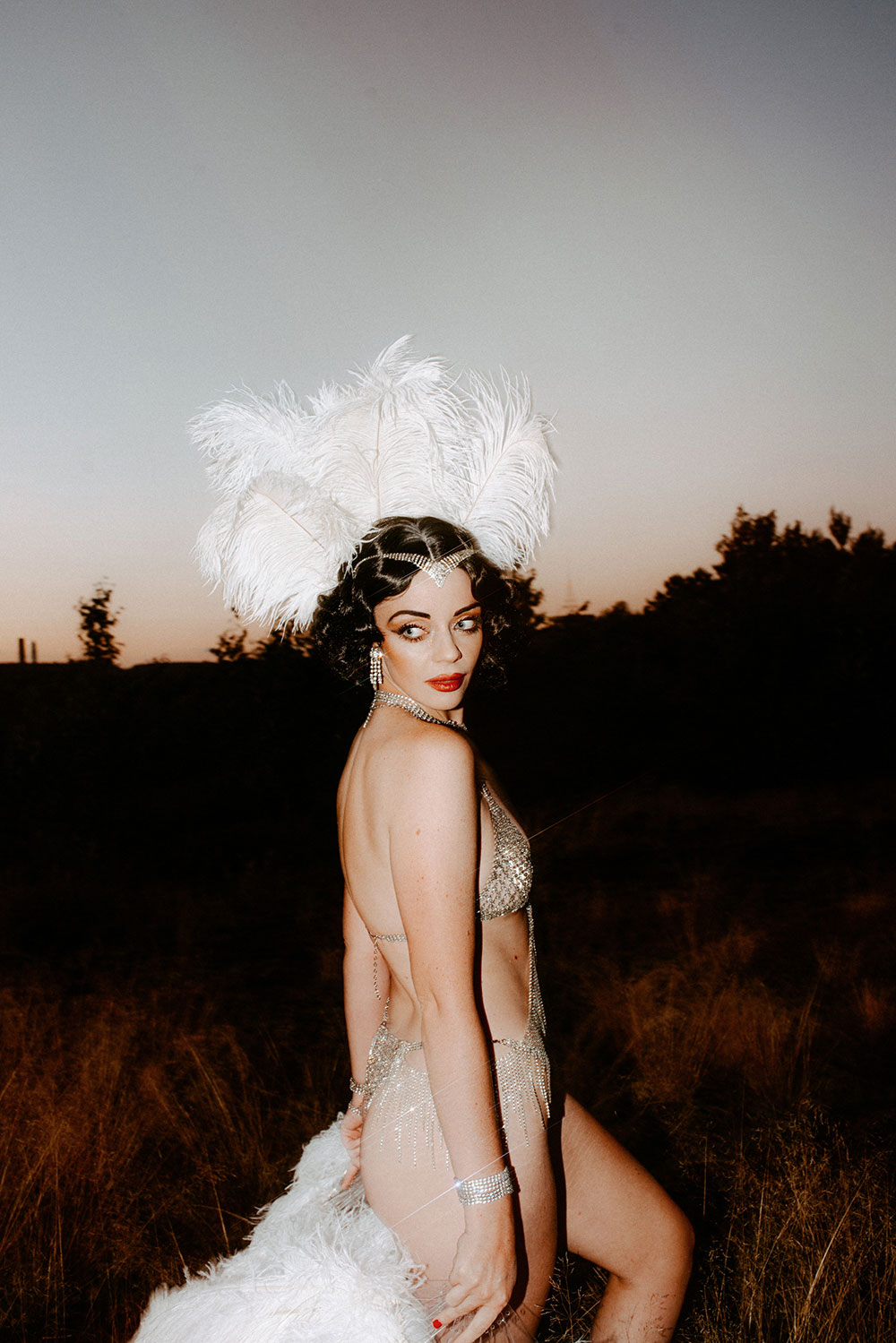 Commercial Photography of Starlotte Satine Toronto Burlesque Dancer in a field wielding large feather fans