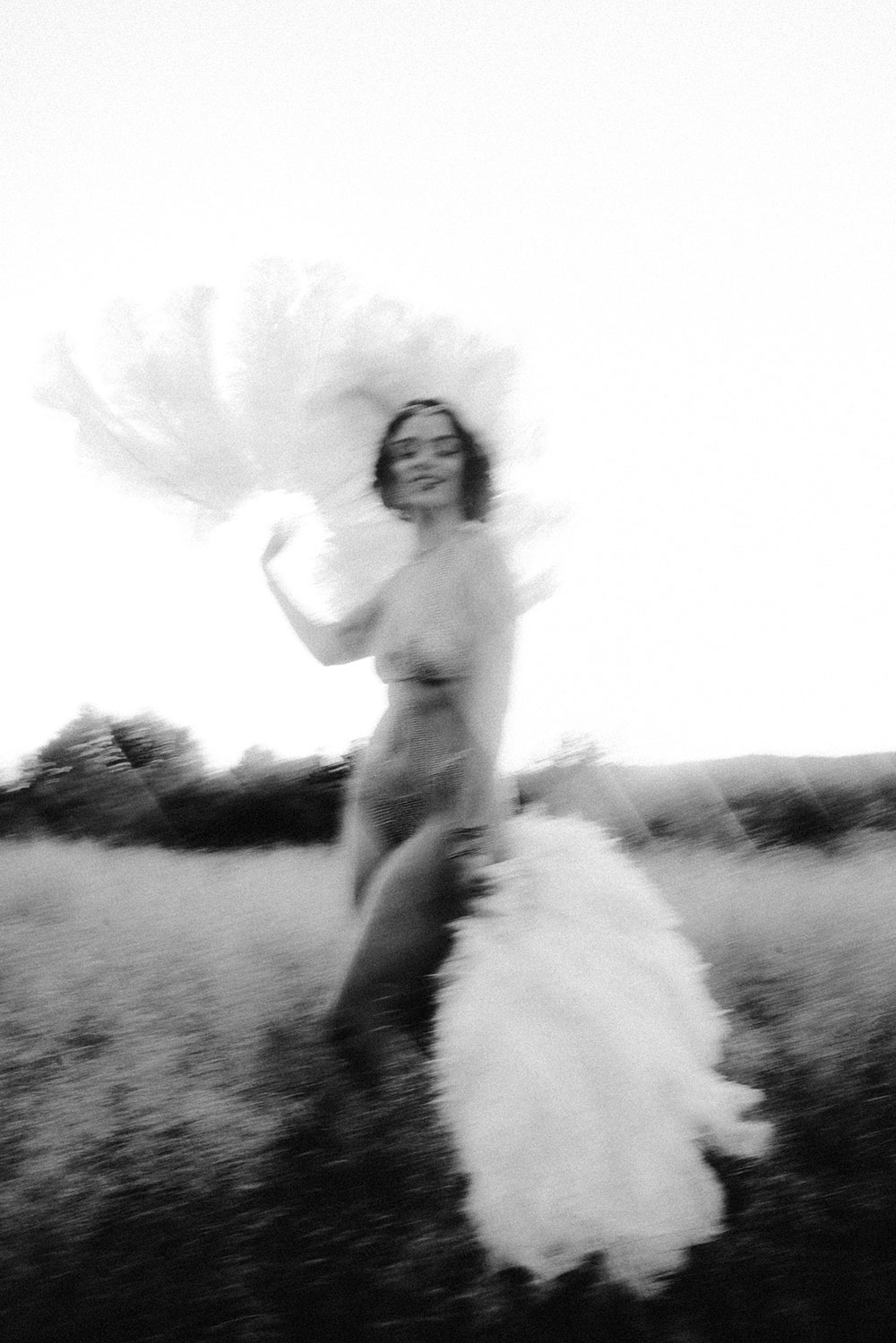 Commercial Photography of Starlotte Satine Toronto Burlesque Dancer in a field wielding large feather fans