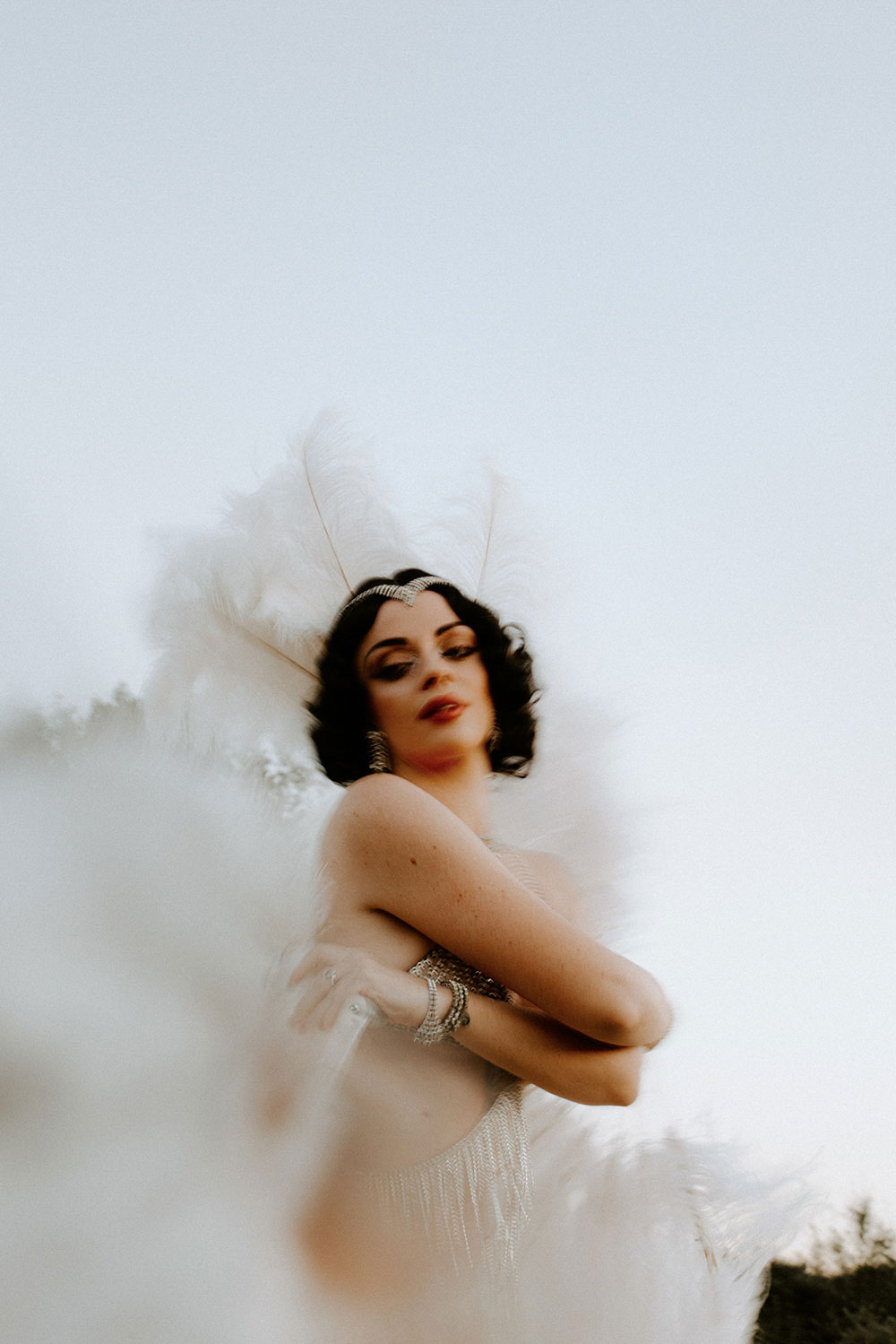 Commercial Photography of Starlotte Satine Toronto Burlesque Dancer in a field wielding large feather fans