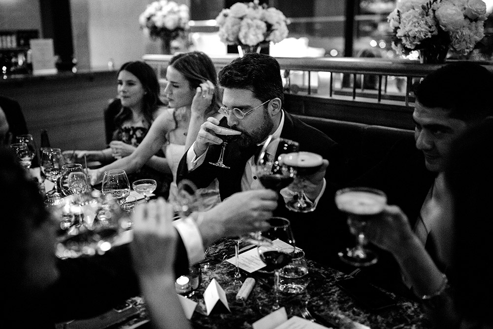 groom sips an espresso martini at this Antonio park wedding 