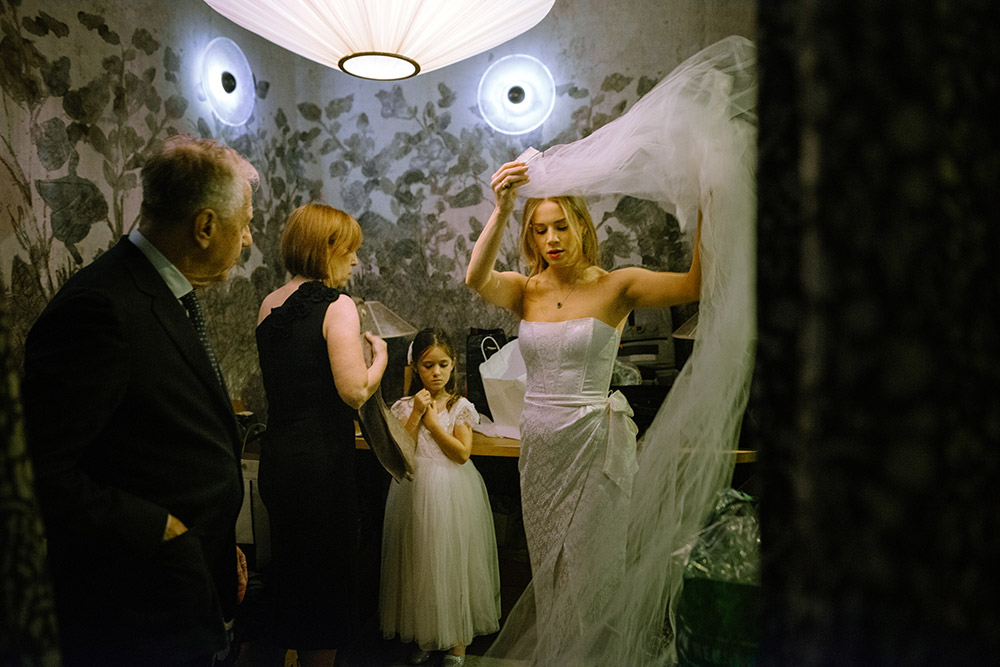 Bride prepares her vail on her wedding day at her Antonio Park wedding in Toronto