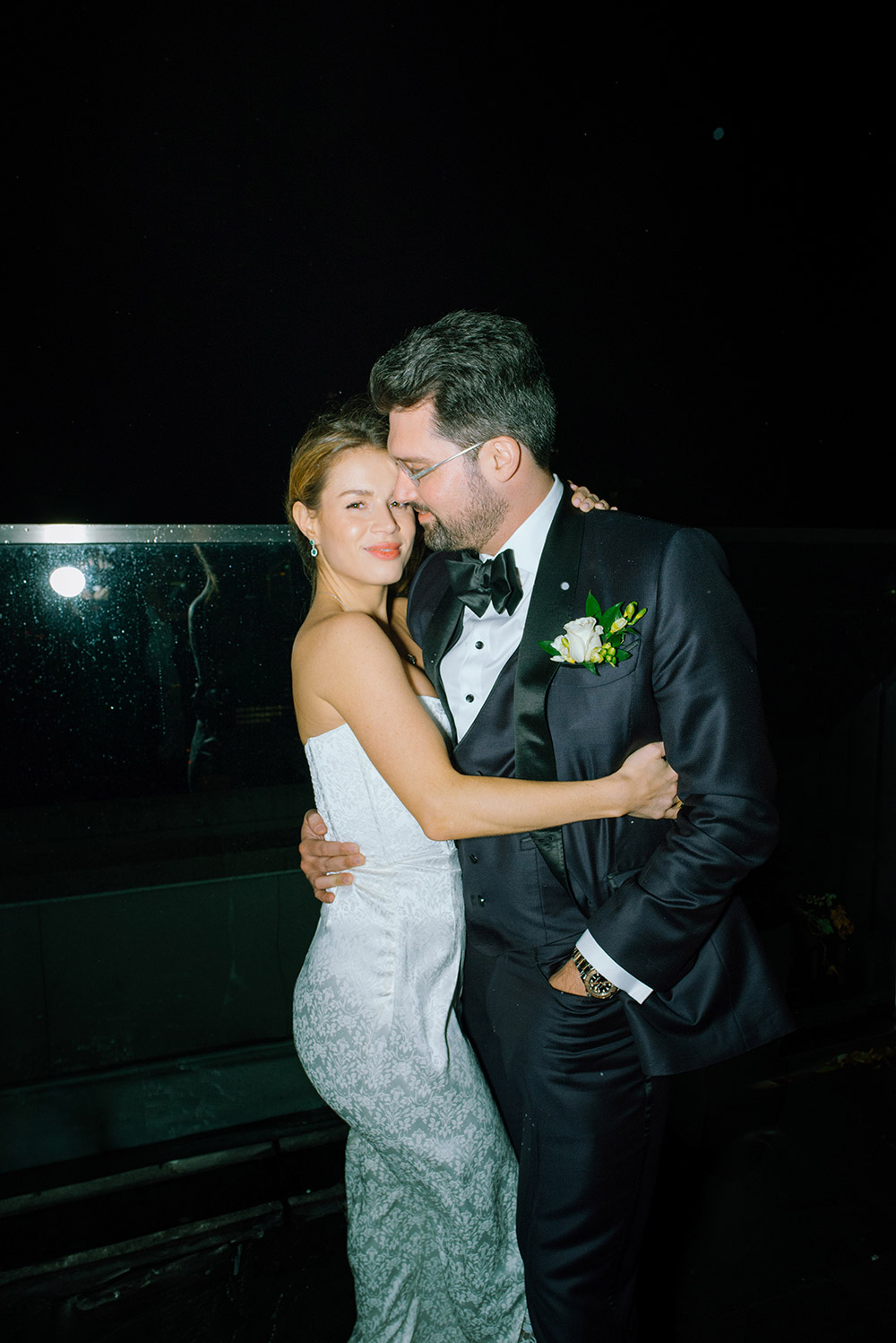 Bride and groom enjoy a brief chilly winter moment on the patio of Antonio Park during their wedding