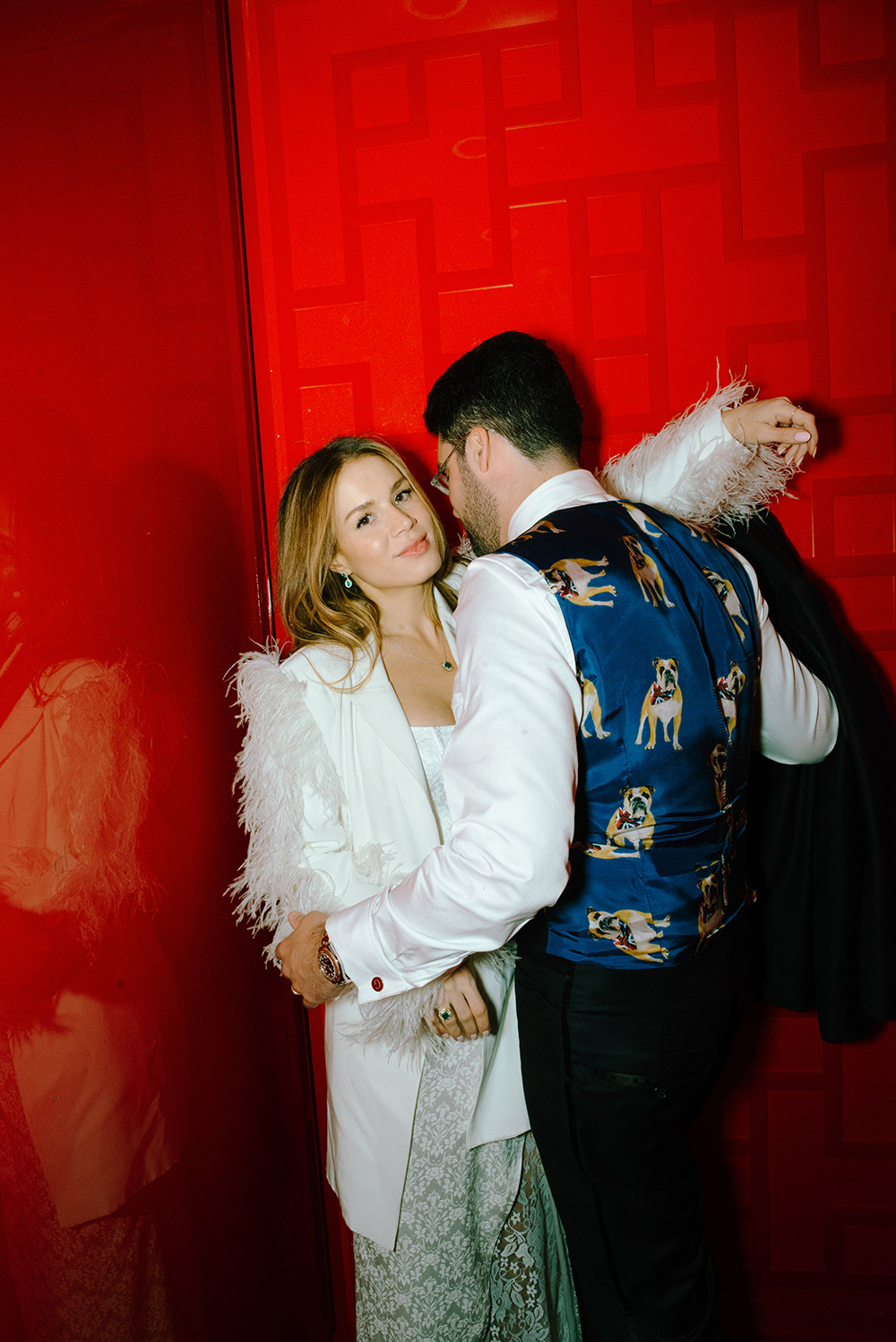 Newlsyweds pose in the red elevator at Antonio Park during their wedding while groom shoes off his snazzy dog printed vest 