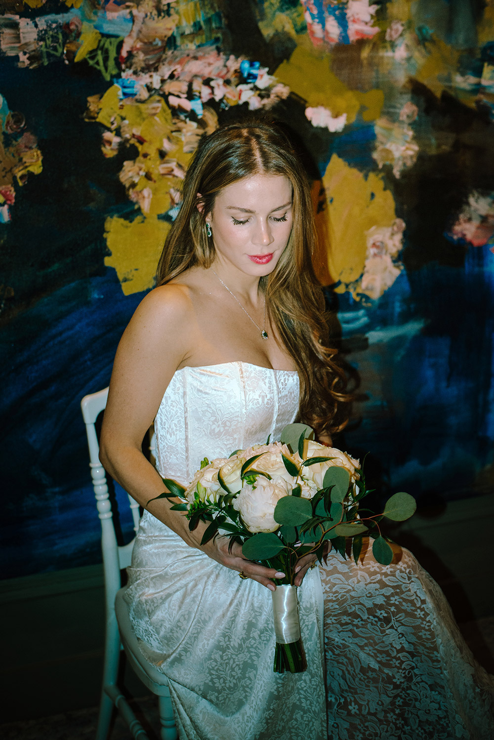 Bride admires her bouquet at her Antonio Park wedding in Toronto